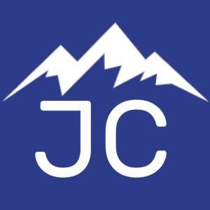 A blue and white logo with mountains in the background